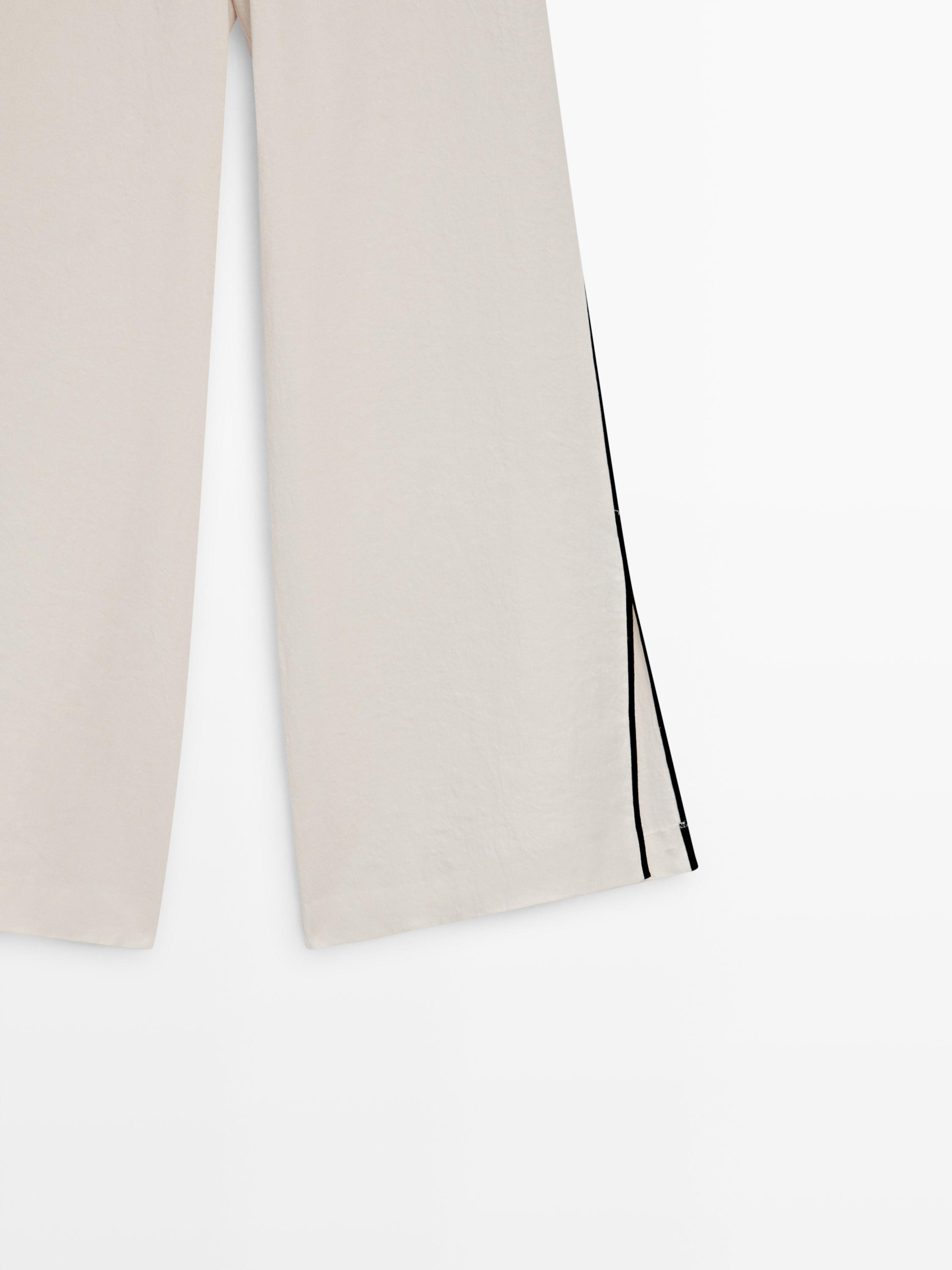 Linen trousers with contrast piping